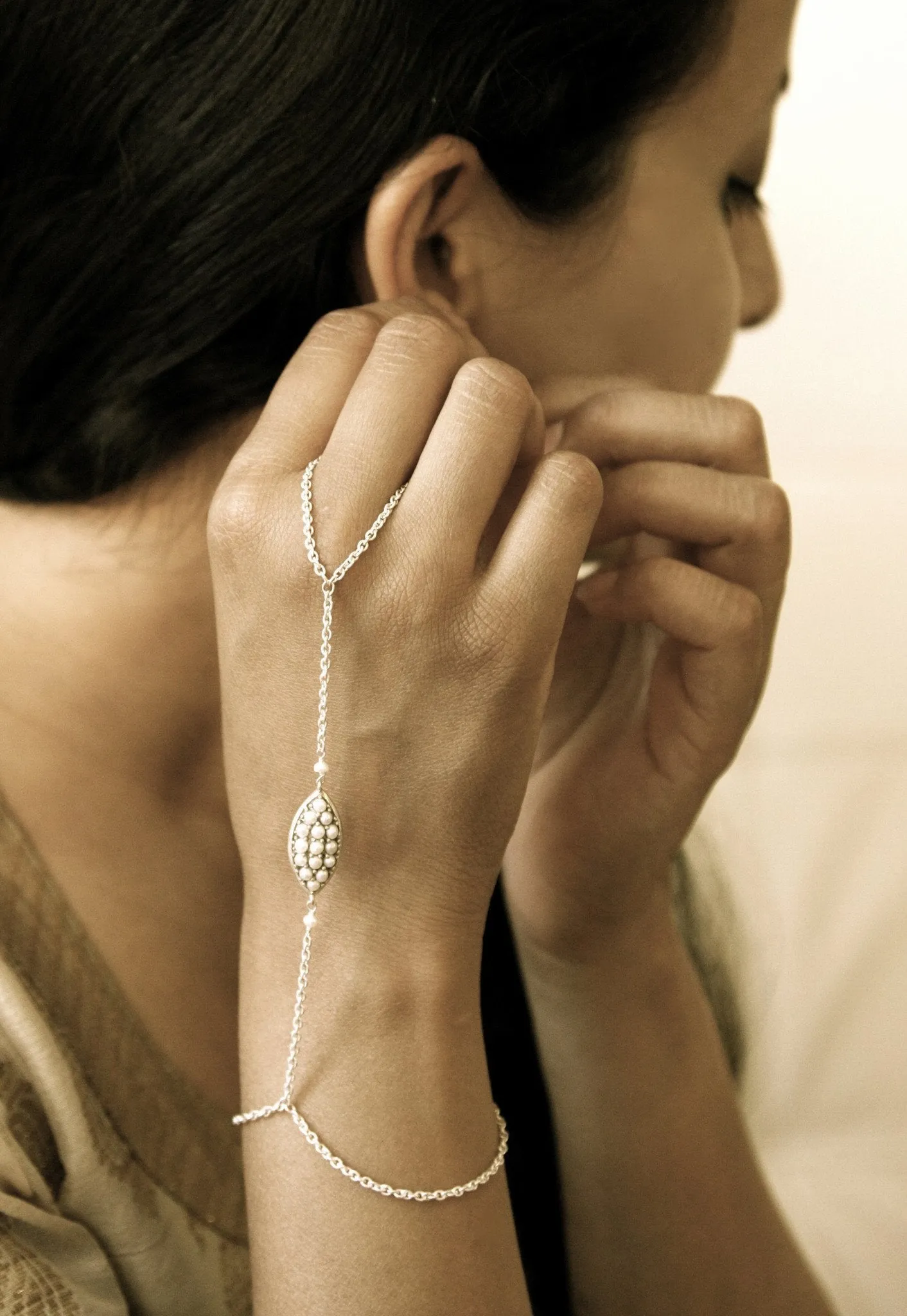 Delicate and chic, pearl encrusted hand harness